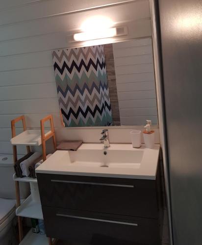 a bathroom with a sink and a mirror at ChEZ MAYAH in Le Gosier