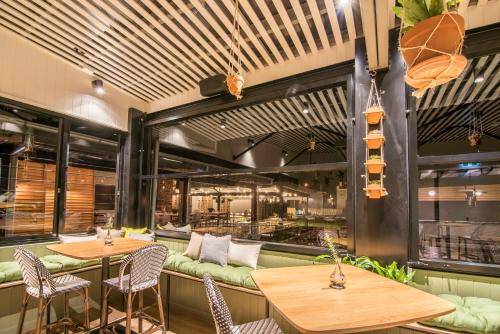 a restaurant with two tables and chairs and a bar at Mercure Orange in Orange