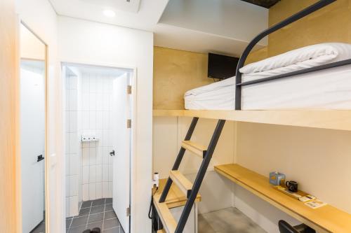 a small room with bunk beds and a shower at Hotel Baroato 2nd in Seoul