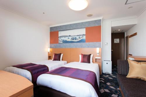 Ένα ή περισσότερα κρεβάτια σε δωμάτιο στο Ryogoku View Hotel