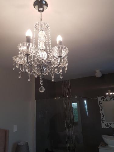 a chandelier hanging from a ceiling in a room at Emmaus-On-Sea in Yzerfontein