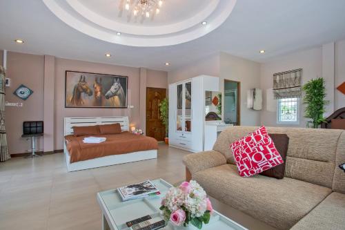 a living room with a bed and a couch at Siam@Sea Resort in Na Jomtien