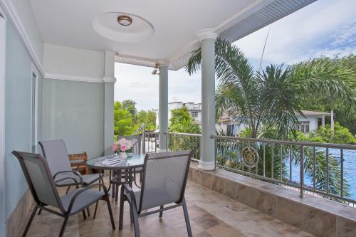 a dining room with a table and chairs on a balcony at Siam@Sea Resort in Na Jomtien