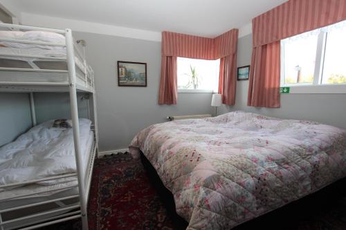 a bedroom with a bed and bunk beds in it at The Viking Country Club in Hjalteyri
