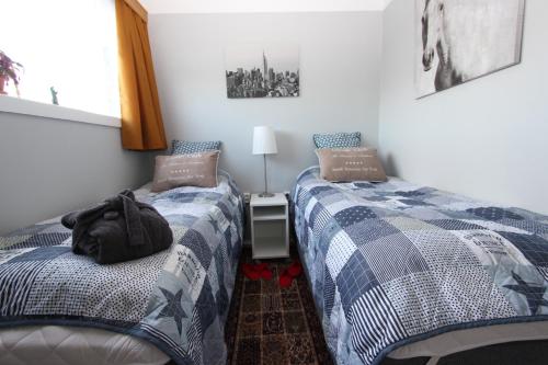 two beds sitting next to each other in a bedroom at The Viking Country Club in Hjalteyri