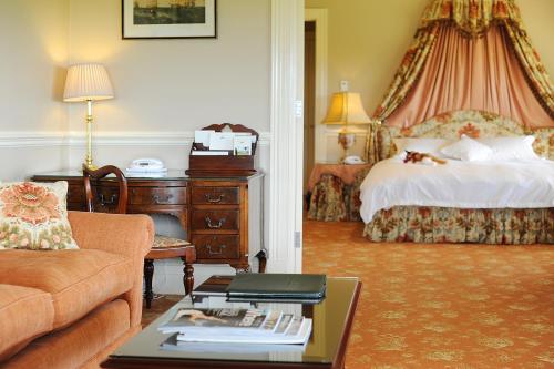 a hotel room with a bed and a couch at Chateau Yering in Yarra Glen