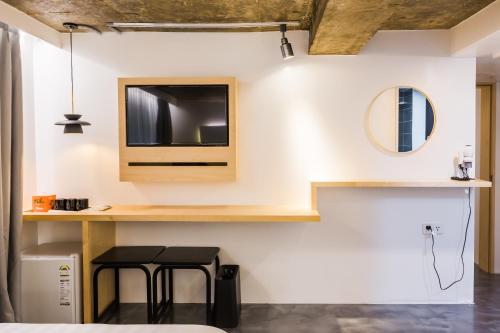 a room with two stools and a tv on the wall at Hotel Baroato 2nd in Seoul