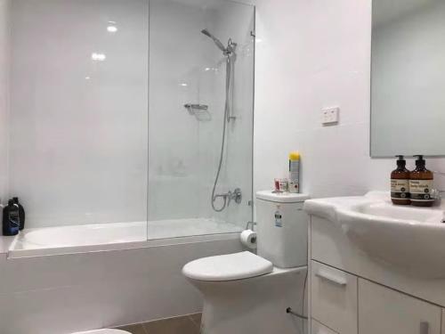 a bathroom with a toilet and a shower and a sink at Shine Apartment in Liverpool