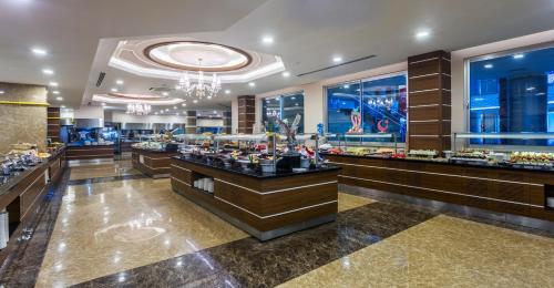 a lobby with a buffet line in a hotel at Lonicera Resort & Spa Hotel - Ultra All Inclusive in Avsallar