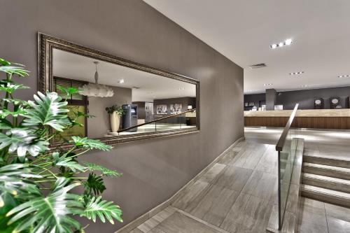 a mirror on the wall of a salon at Interhotel Sandanski in Sandanski