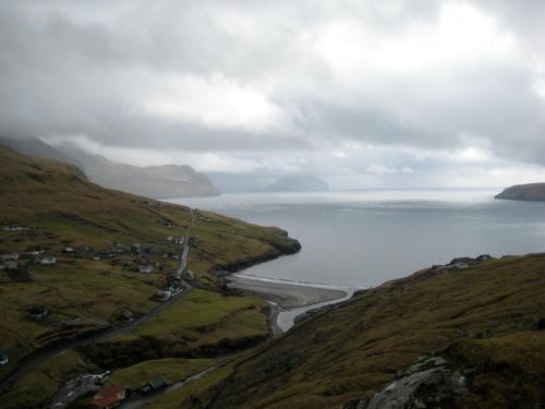 a view of the ocean from a hill at Idyllic house near river and ocean in Leynar