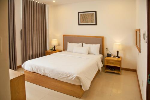 Elegant Hotel tesisinde bir odada yatak veya yataklar