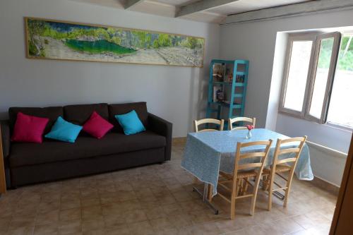 een woonkamer met een bank en een tafel bij La P'tite Maison in Saint-Hostien