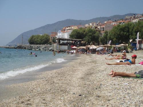 a group of people laying on a beach at NICK STUDIOS previous NICK HOUSE in Plomarion