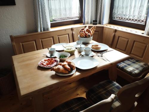 a wooden table with plates of food on it at Ferienhaus in der Schlipfing mit Garten in Altmünster