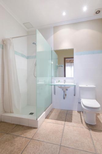 a bathroom with a shower and a toilet and a sink at Hostal Tres Molins in Jesus Pobre