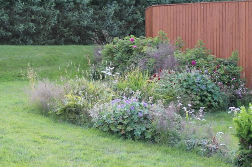 a garden with colorful flowers in a field at The Viking Country Club in Hjalteyri
