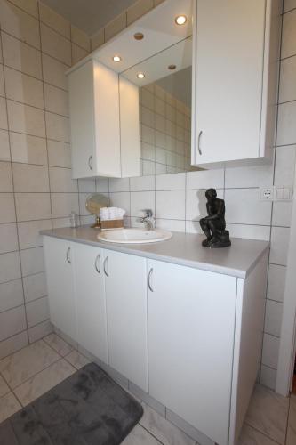 a bathroom with a white sink and a mirror at The Viking Country Club in Hjalteyri