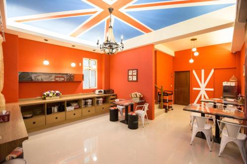 a large kitchen with orange walls and a ceiling with a flag at England B&B in Taiping