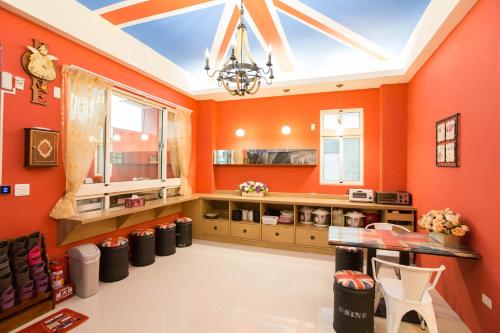 a kitchen with orange walls and a skylight at England B&B in Taiping