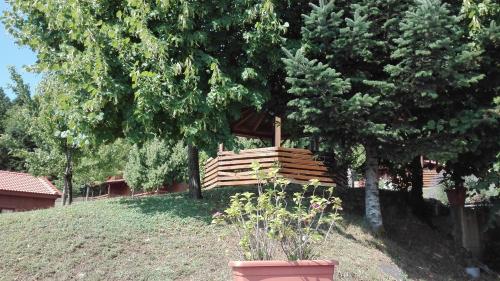 a wooden bench sitting on top of a hill at Livadaki Village in Megáli Kápsi