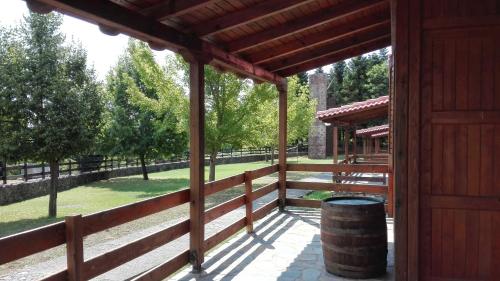 a wooden pavilion with a barrel in a park at Livadaki Village in Megáli Kápsi