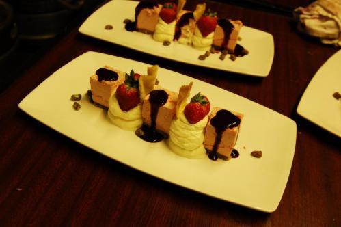 two white plates with desserts on a wooden table at Lynhams Hotel in Laragh