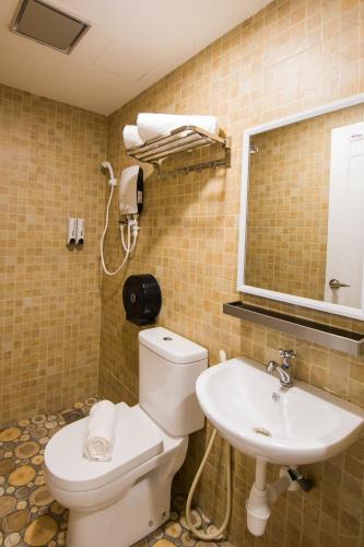 a bathroom with a toilet and a sink at Lavender Inn USJ in Subang Jaya