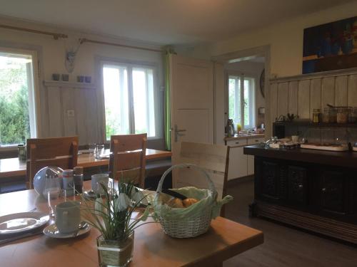 a dining room with a table with a basket on it at Frühstückspension Gsenger in Ramsau am Dachstein
