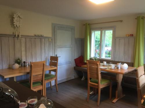 a dining room with a table and chairs and a window at Frühstückspension Gsenger in Ramsau am Dachstein