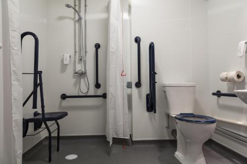 a bathroom with a toilet and a shower stall at Spread Eagle, Gailey by Marston's Inns in Gailey