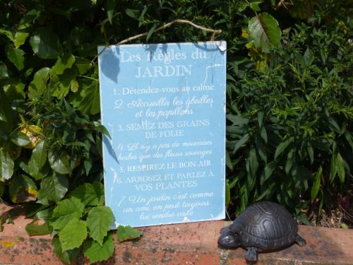 a sign with a turtle in front of a sign at Gîte de Charme Les Petits Matins Bleus in Sainte-Marguerite-de-Viette