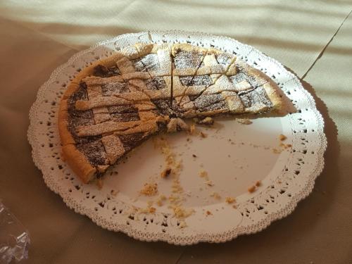 a piece of cake on a plate on a table at B&B Lu Casale in San Cesario di Lecce