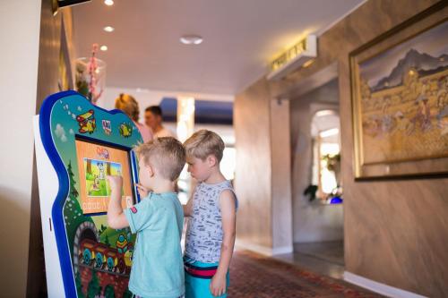 two young boys standing in front of a toy display at Hotel Ca' Di Valle in Cavallino-Treporti