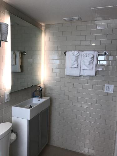 a bathroom with a sink and a toilet and towels at Captiva Beach Resort (open private beach access) in Sarasota