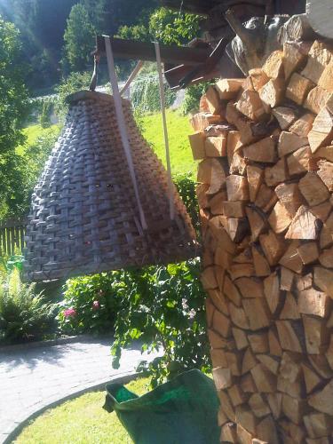 a large basket hanging from a stone wall at Landhaus Seiringer Apartments in Finkenberg