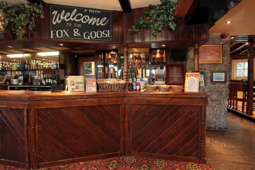 a bar with a welcome to the fox and goose sign at Fox & Goose, Barrow Gurney by Marston's Inns in Bristol