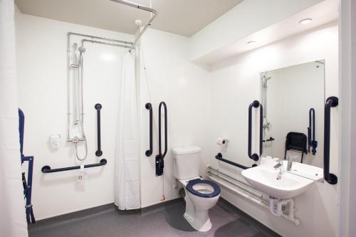 La salle de bains est pourvue de toilettes, d'un lavabo et d'un miroir. dans l'établissement Lobster Pot, Bridlington by Marston's Inn, à Bridlington