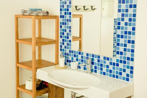 a bathroom with a sink and a mirror at Moulin Pont Vieux Chambres d'hôtes in Mortagne-sur-Sèvre