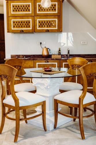 a kitchen with wooden chairs and a table at Villa Nepos Hotel in Split