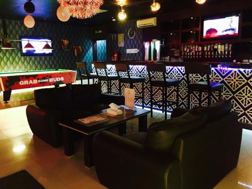 a bar with couches and a table in a room at Mutrah Hotel in Muscat