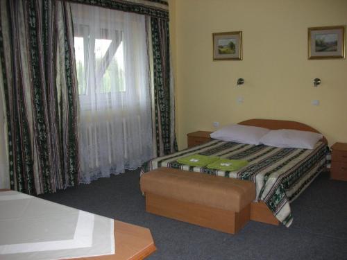 a hotel room with a bed and a window at Zajazd Kosynier in Węgrzce