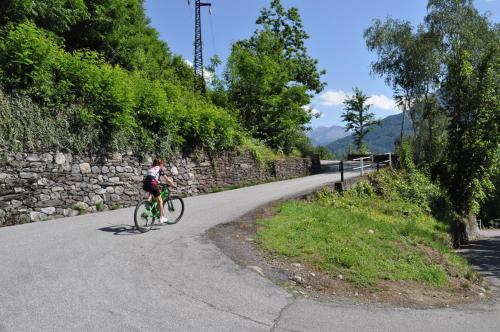 a person riding a bike down a road at Hotel Ristorante Franca in Tovo di Sant'Agata