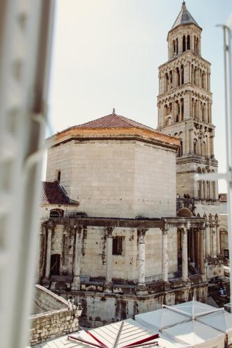 an old building with a tower and a church at Villa Nepos Hotel in Split