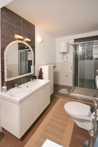 a bathroom with a sink and a shower and a toilet at LibeTrogir in Trogir