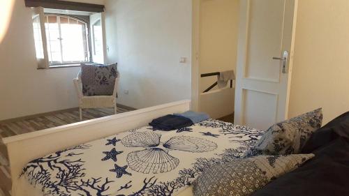 a room with a bed and a chair in it at La Barca di Pozzillo in Acireale