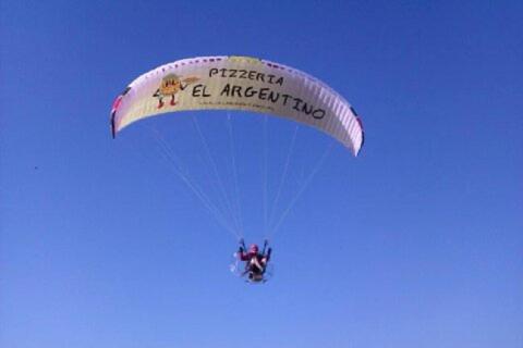 a person riding a parachute in the sky at Caminito ARG in La Bañeza