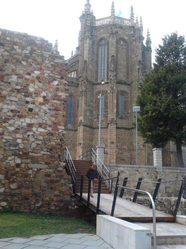 a person sitting on the stairs in front of a building at Caminito ARG in La Bañeza