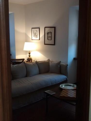 a living room with a couch and a table at La Pomella in Ponte Nizza