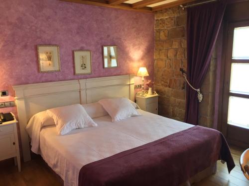 
a hotel room with a bed and a window at Las Mayas Posada-Restaurante-Spa in Quintanar de la Sierra

